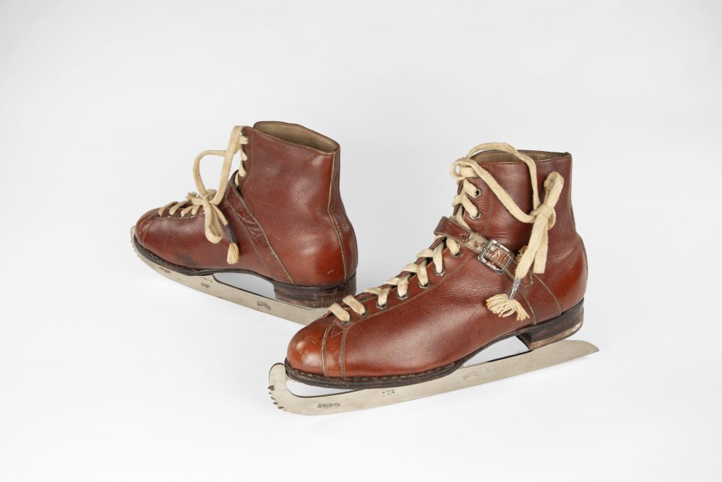 Boot upper of reddish brown leather with 11 pairs of metal eyelets for off-white lace up the front. Strap over instep fastens with metal buckle.